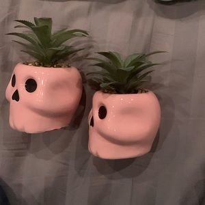 A set of two pink skull fake plant decor.